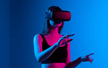 Portrait of woman video game designer wearing VR headset and interact with virtual environment or application.