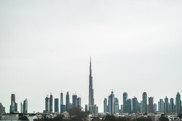 Fototapeta na wymiar Dubai skyline with Burj Khalifa and many buildings on the horizon
