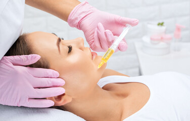 Cosmetologist does prp therapy of a beautiful woman in a beauty salon. Cosmetology concept.