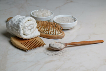 wooden items, a hairbrush, and body care products. bath salt, natural clay, and sponge. means for relaxation and rest. meditation and spa treatments