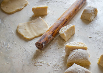 dough and flour on the table. cooking gingerbread. knead the dough to make a pie. grandmother prepares a cupcake. mom makes sweets.