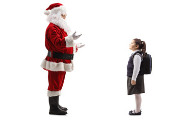 Santa claus talking to a schoolgirl with a backpack