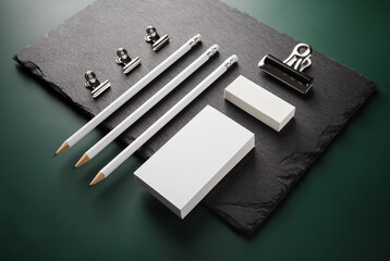Photo of blank stationery set on stone board. Responsive design template.