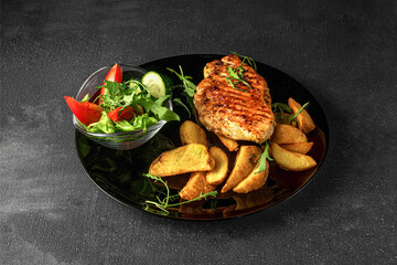 Chicken fillet with baked potatoes and fresh vegetables