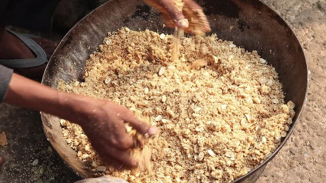 Mixing Sesame Seeds, Kaju Badam Moonfali Mawa Malai Mungfali Nuts Mava With Hands By Cook Halwai In Dhaba For Making Til Gul Gajak Laddu Or Ball Shaped Tilgul Gazak Ladoo For Makar Sankranti And Lohri