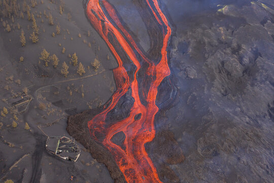 Aerial top down view of lava floating down the Volcan Cumbre Vieja, a volcano during eruption near El Paraiso town, Las Manchas, La Palma Island, Canary Islands, Spain.