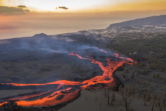 Aerial top down view of lava floating down the Volcan Cumbre Vieja, a volcano during eruption near El Paraiso town, Las Manchas, La Palma Island, Canary Islands, Spain.