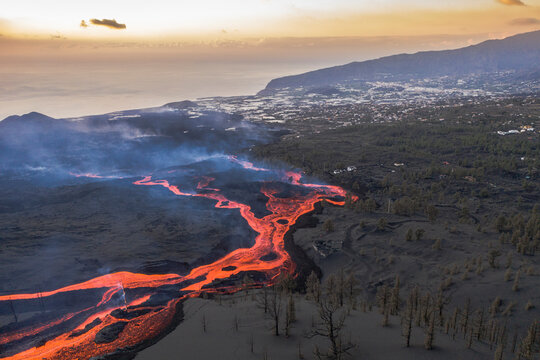 Aerial top down view of lava floating down the Volcan Cumbre Vieja, a volcano during eruption near El Paraiso town, Las Manchas, La Palma Island, Canary Islands, Spain.