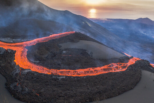 Aerial top down view of lava floating down the Volcan Cumbre Vieja, a volcano during eruption near El Paraiso town, Las Manchas, La Palma Island, Canary Islands, Spain.