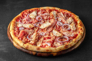 Pizza on a fluffy dough on a black background