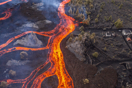 Aerial top down view of lava floating down the Volcan Cumbre Vieja, a volcano during eruption near El Paraiso town, Las Manchas, La Palma Island, Canary Islands, Spain.