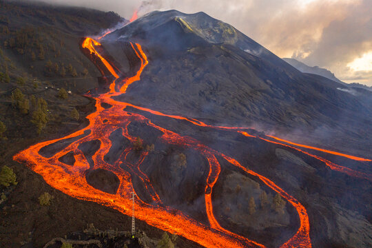 Aerial top down view of lava floating down the Volcan Cumbre Vieja, a volcano during eruption near El Paraiso town, Las Manchas, La Palma Island, Canary Islands, Spain.