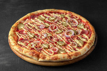 Pizza on a fluffy dough on a black background