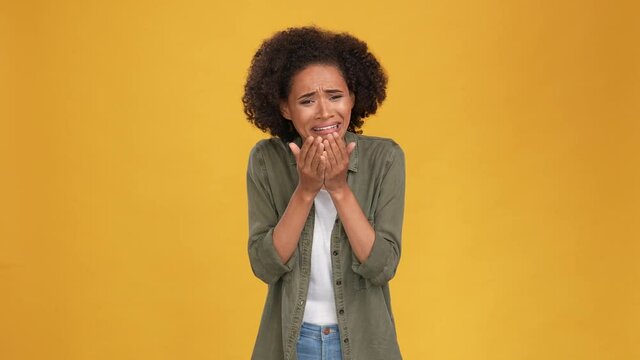 Frustrated lady cry sever close face hands isolated mustard color background