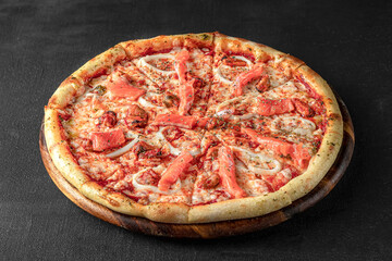 Pizza on a fluffy dough on a black background