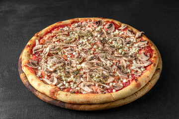 Pizza on a fluffy dough on a black background