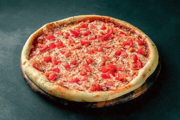Pizza on a fluffy dough on a black background