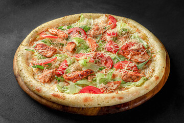 Pizza on a fluffy dough on a black background