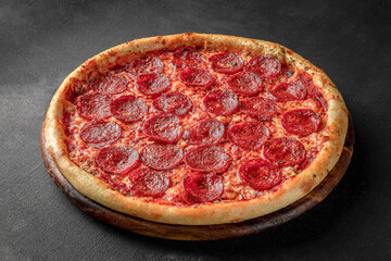 Pizza on a fluffy dough on a black background