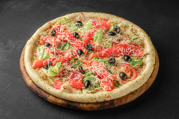 Pizza on a fluffy dough on a black background