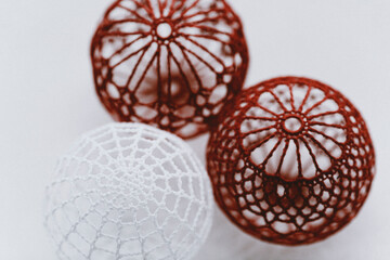 Christmas ball with macrame-style weaving,handmade decor in eco-style,hands close-up,top view. Christmas, New Year and eco-friendly concept