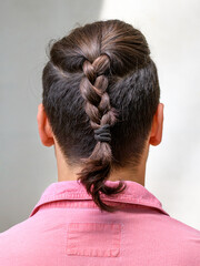 Fototapeta premium men's hairstyle with braided hair. Close-up photo from behind