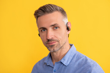 new technology. successful unshaven guy. agile business. handsome man with wireless headphones