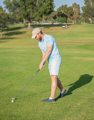 active man playing golf game on green grass, summer