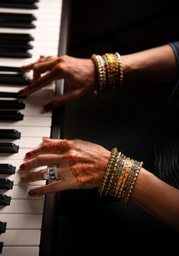 Henna hands playing the  piano 