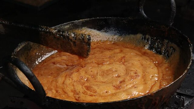 Sweet Sugar And Jaggery Syrup Called Chasni Gud Ka Paag Is Almost Ready. Indian Halwai In Dhaba Simmer Vigorously Continuously The Sticky Gur And Cheeni Mix As It Reaches To Completion