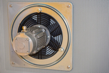 Exhaust fan with built-in electric motor. Exhaust fan on wall of room. Silver exhaust fan....