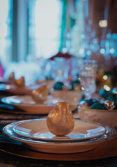 festive gold pear decoration on fancy table scene. christmas holiday