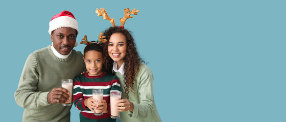 African-American family with Christmas decor and tasty hot chocolate on color background with space for text