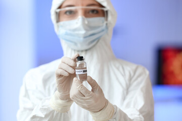Scientist with covid-19 vaccine in laboratory