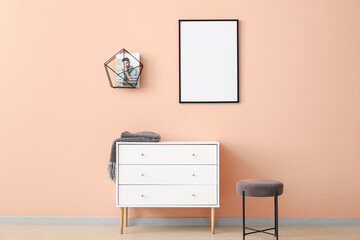 Chest of drawers and blank poster in modern room