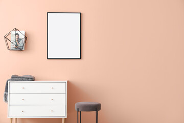 Chest of drawers and blank poster in modern room