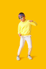 Dancing little boy on color background