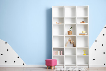 Modern shelf unit and pouf in room