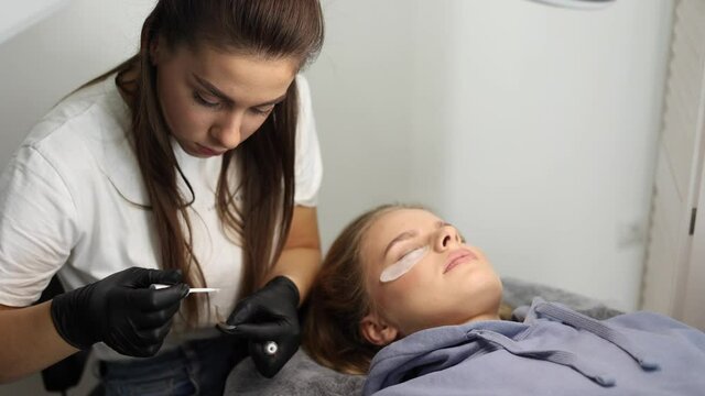 Young woman preparing for making eyelashes lamination in beauty studio