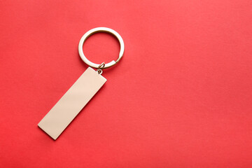Stylish keychain on red background