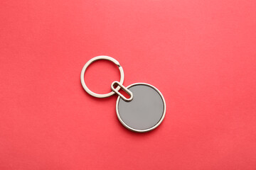 Stylish round keychain on red background