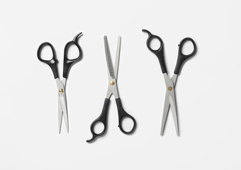 Scissors of hairdresser on white background, top view