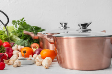 Cooking pot and ingredients for delicious soup on table