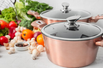 Cooking pot and ingredients for delicious soup on table