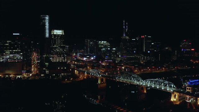 Night time city aerial moving towards skyline of downtown Nashville TN, 4K