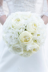 Bride's white bouquet and wedding dress
