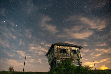 ruins of abandoned house under cloudy night sky