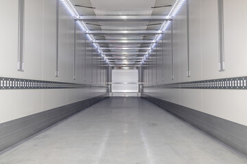 A big new empty refrigerated trailer inside. Inner space of the semi-trailer for transporting...
