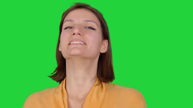 Happy girl laughing. Fun facial expressions of girl looking at camera. Green screen technique.