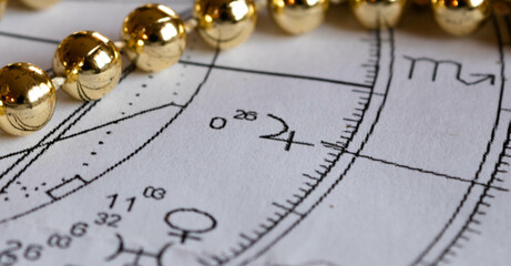 Detail of an astrological chart with Jupiter  planet, Christmas decoration in the background